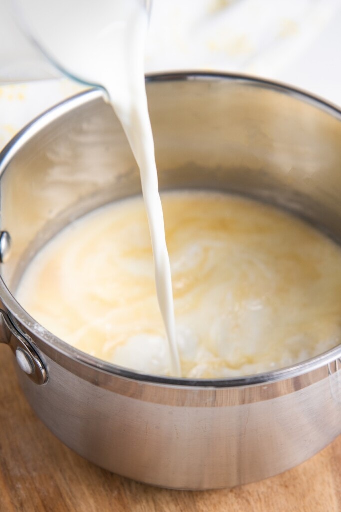 Milk poured into a mixture of flour and butter.