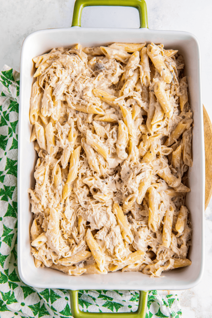 Chicken and penne pasta in a baking dish.