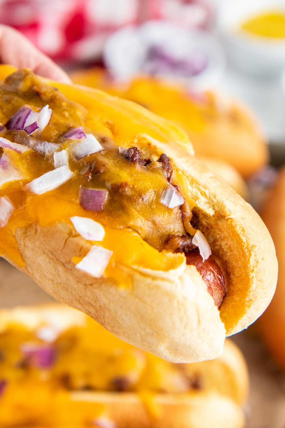 Hot dogs topped with hot dog chili and melted cheese.