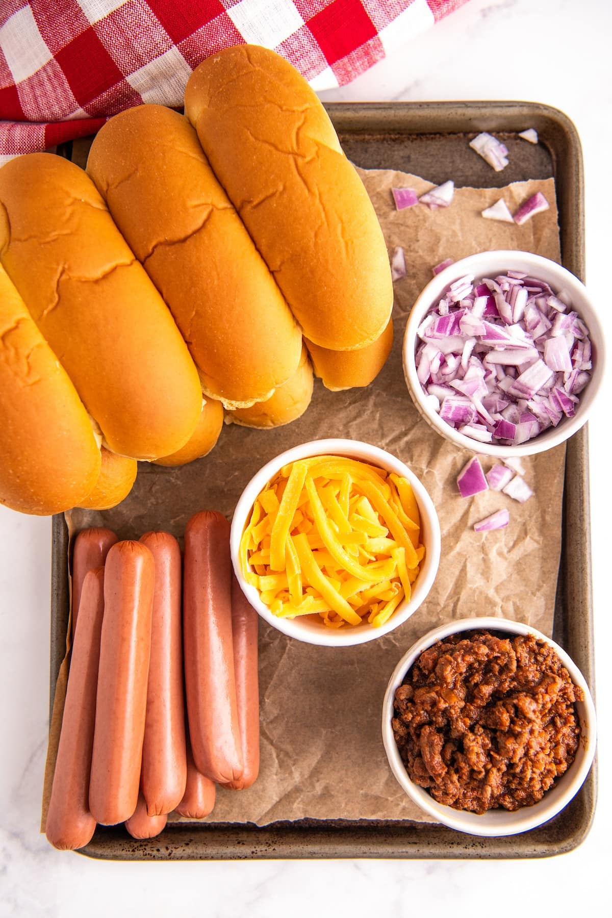 Chili dogs ingredients on a tray.