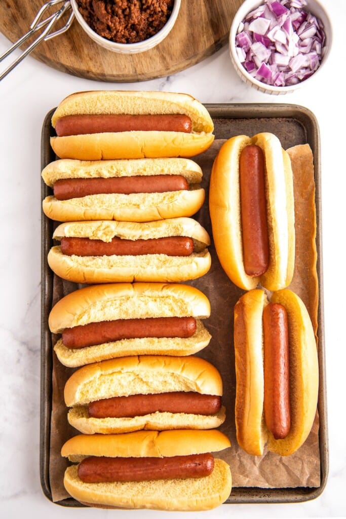 Hot dogs in buns on a tray.