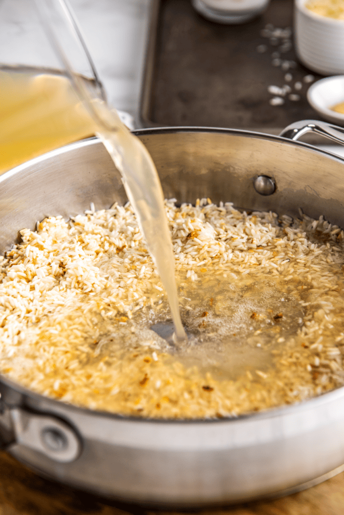 Chicken broth poured into a pan of rice.