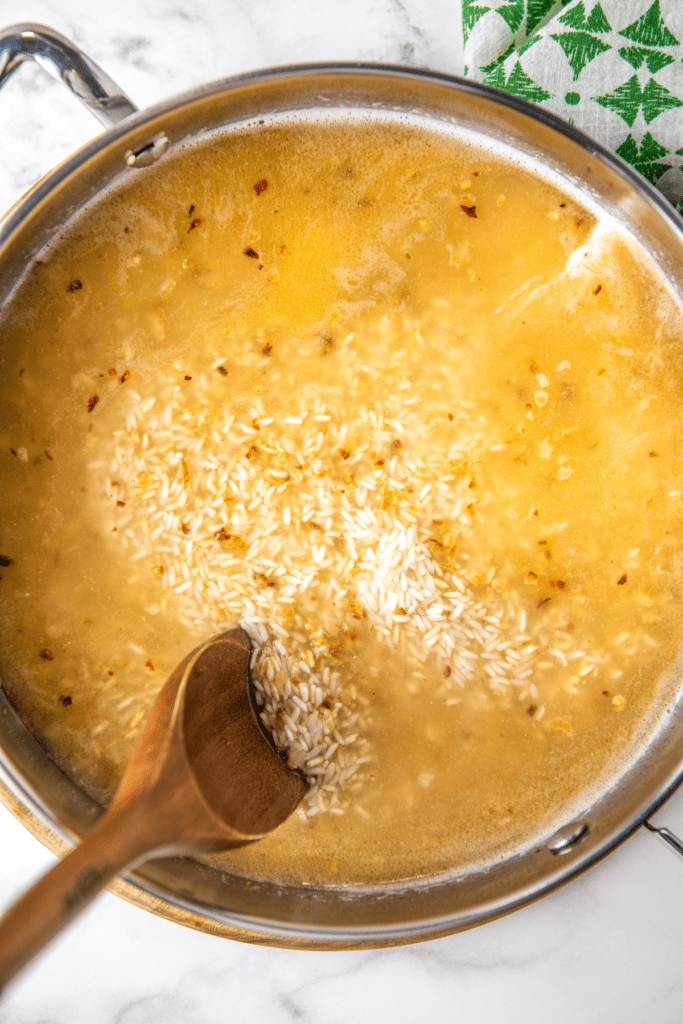 Long grain rice cooking in chicken broth.