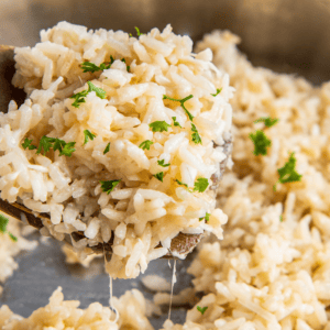 Parmesan garlic rice with fresh parsley on top.