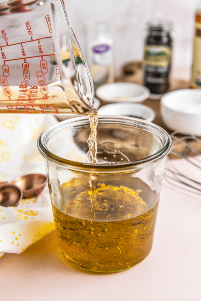 Olive oil and vinegar poured into a jar.