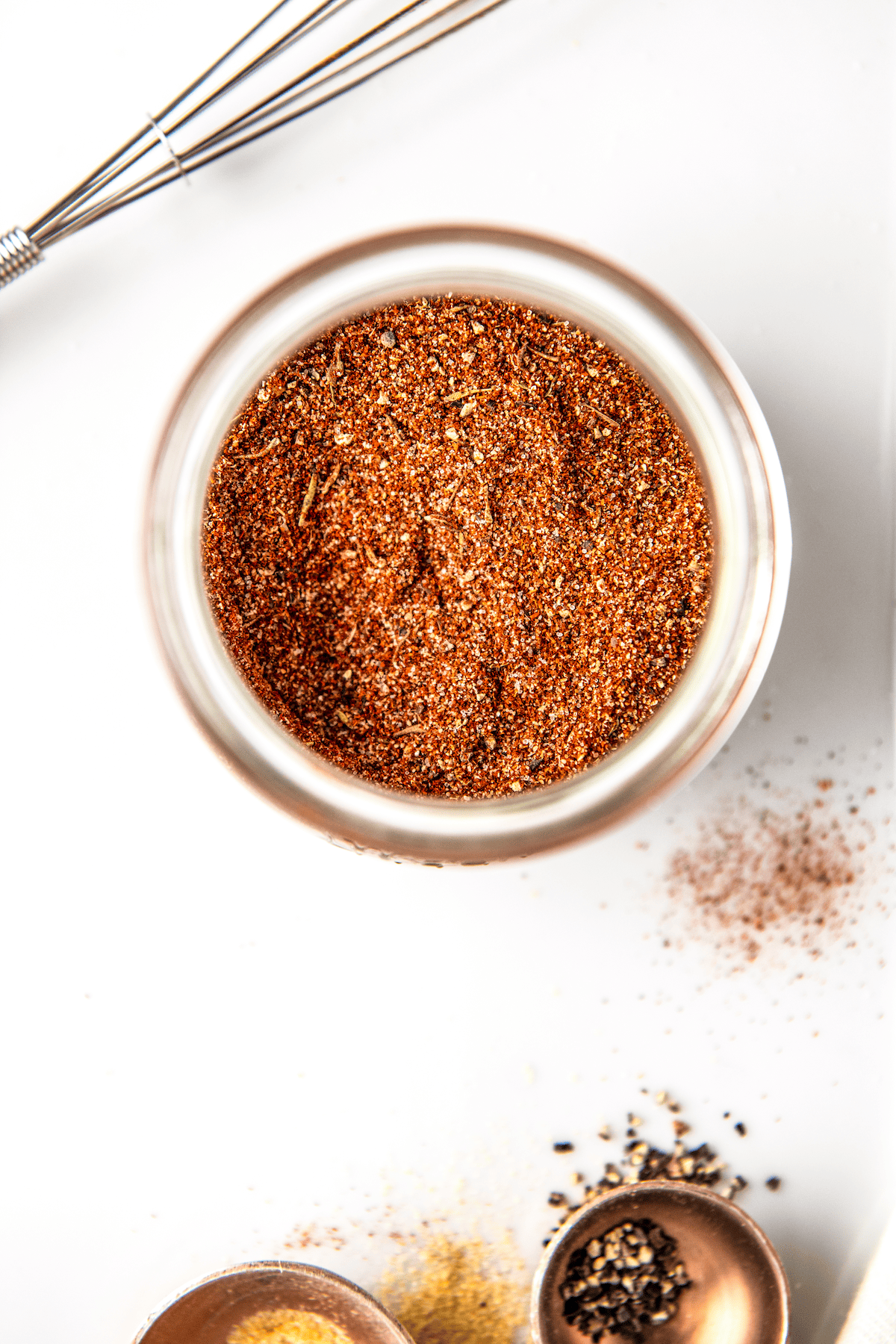 Whisked pork chop seasoning in a jar.