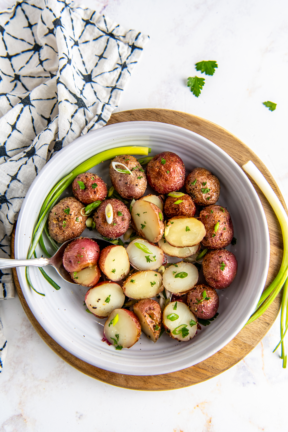 Halved roasted baby potatoes in a bowl.