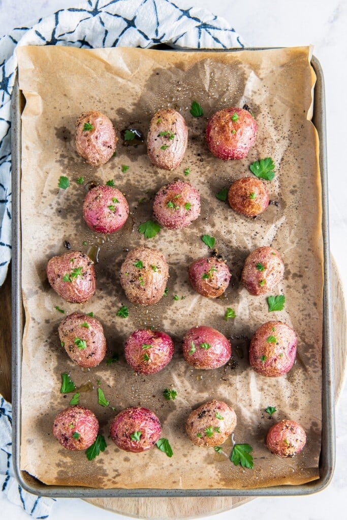 Roasted baby potatoes on a baking sheet.