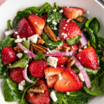 Spinach strawberry salad with red onion.