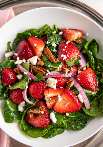 Spinach strawberry salad with red onion.