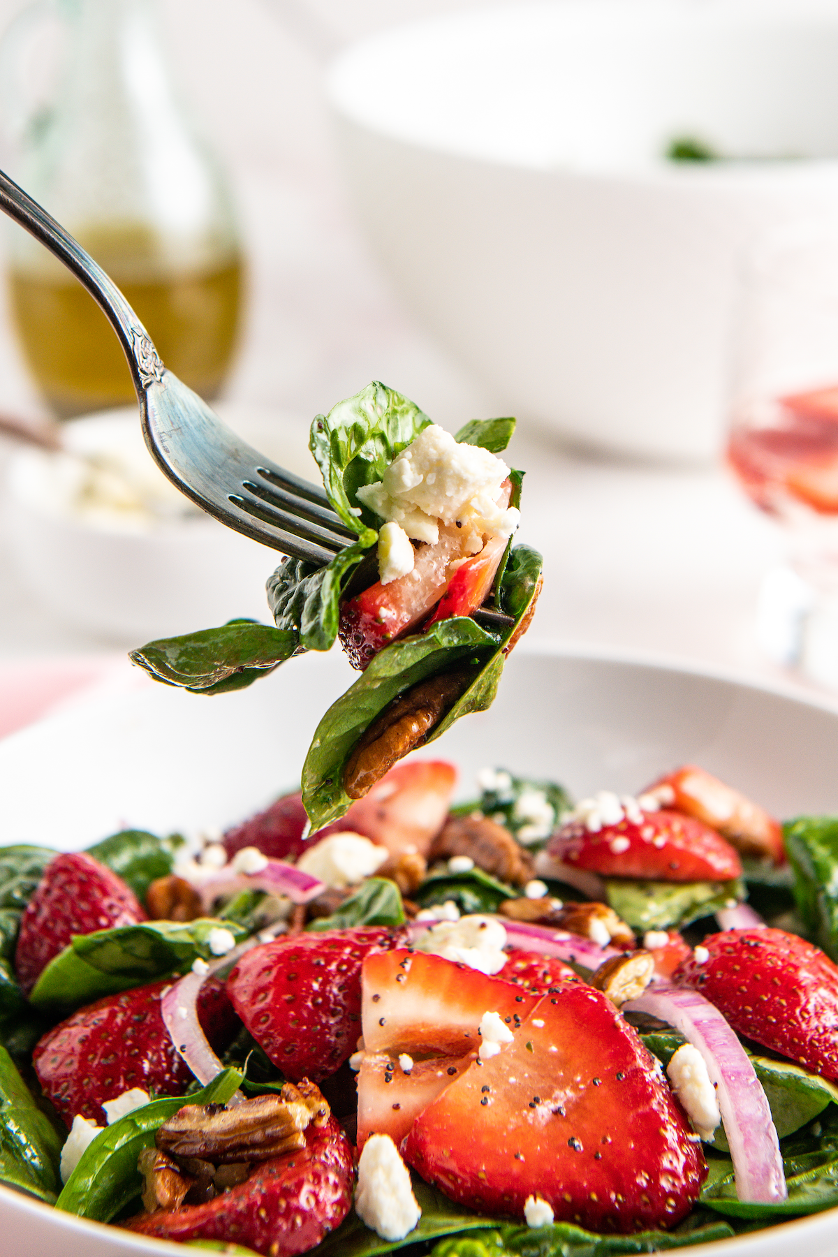 Forkful of spinach strawberry salad.