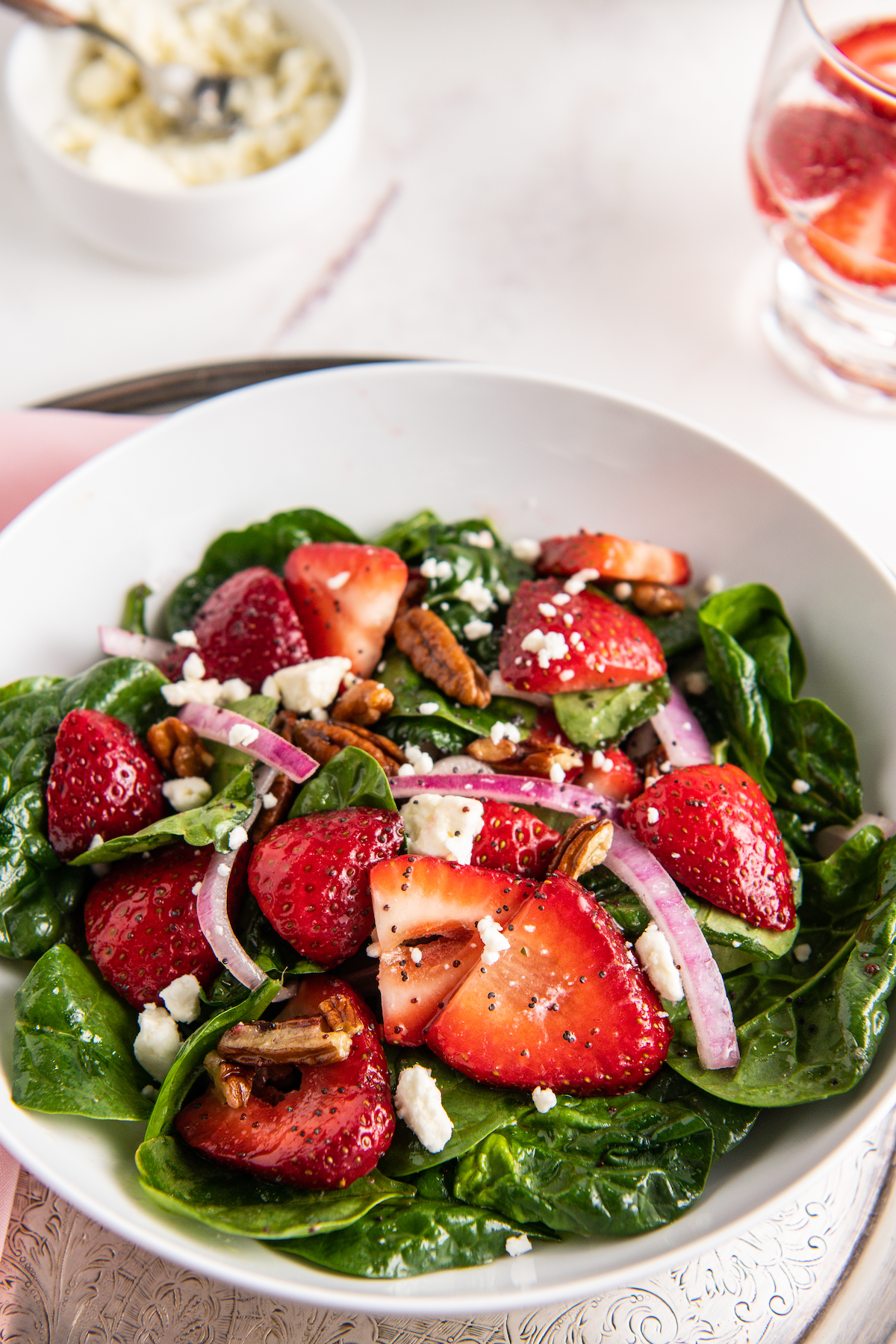 Strawberry salad with feta cheese, pecans, and baby spinach.