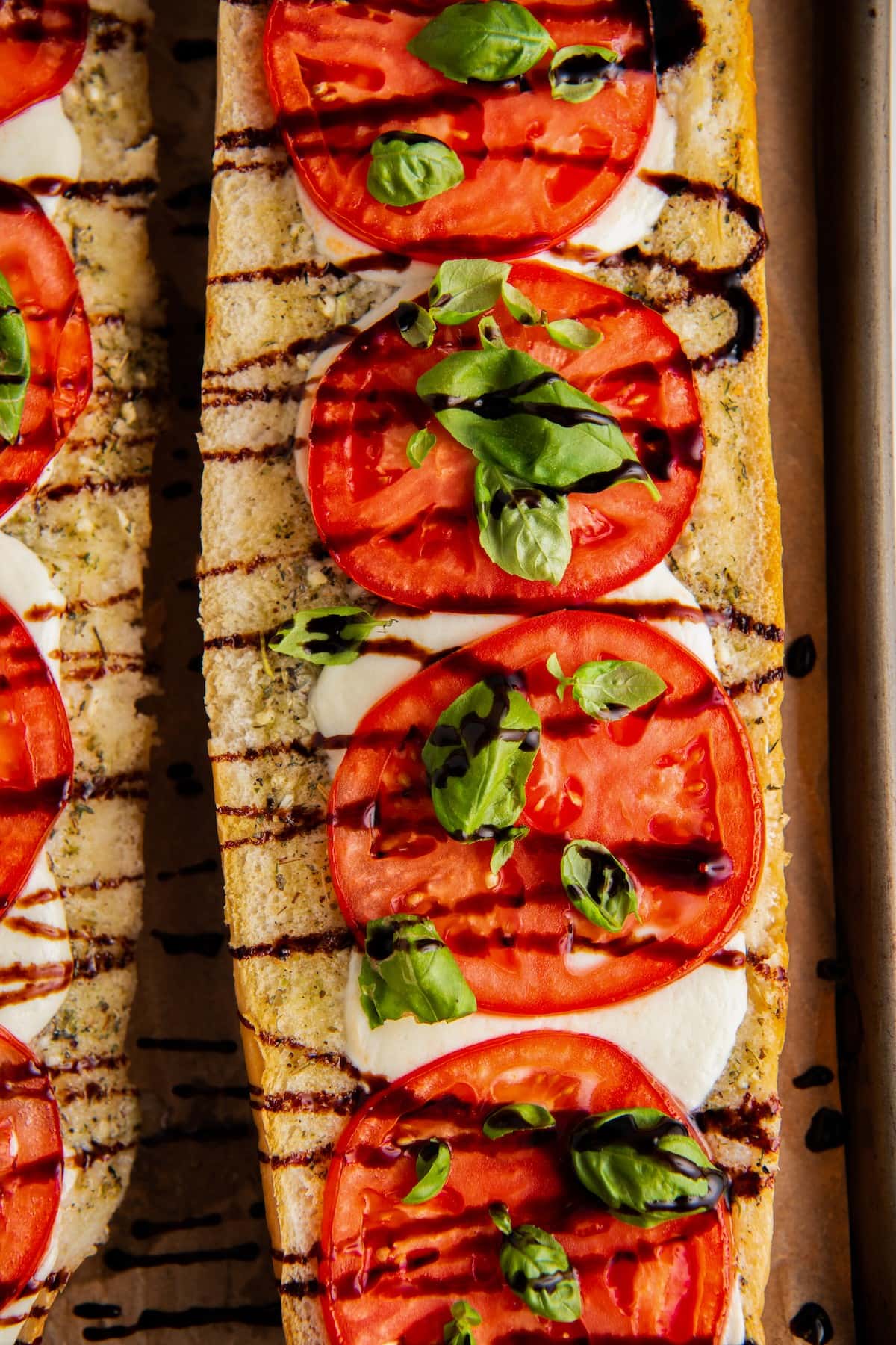 Close up of a loaf of Caprese sandwich drizzled with balsamic