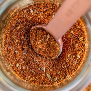 A bowl of chicken taco seasoning with a measuring spoon in it.