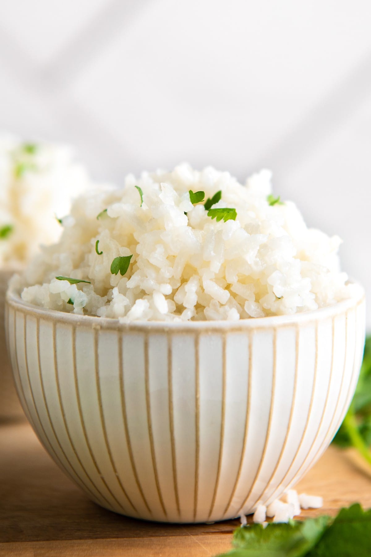 A bowl of coconut rice topped with cilantro