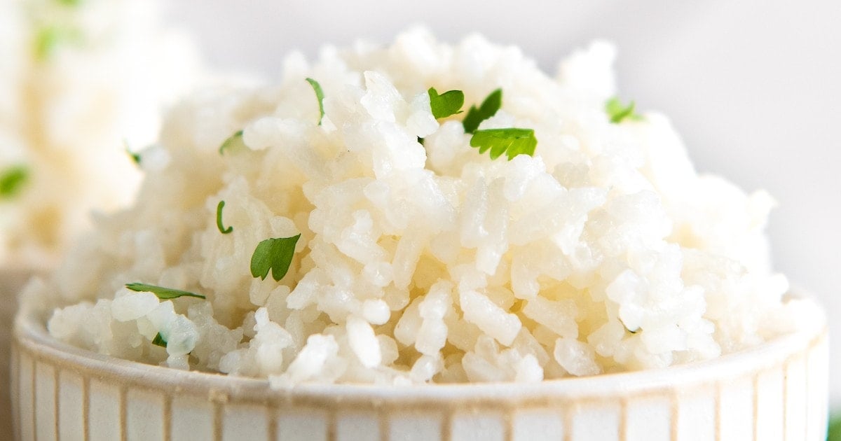 Close up of a bowl of coconut rice topped with cilantro
