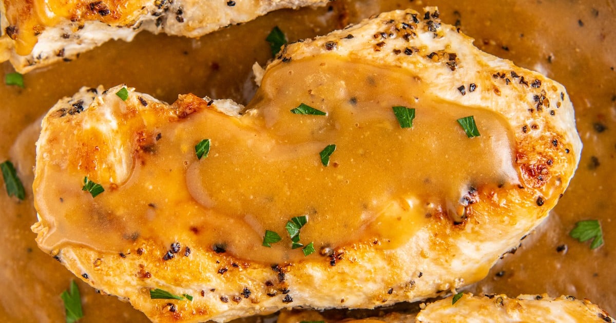Close up of a chicken breast covered in gravy