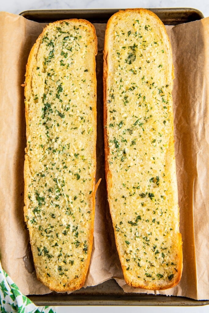 Overhead view of two loaves of baked garlic bread without cheese
