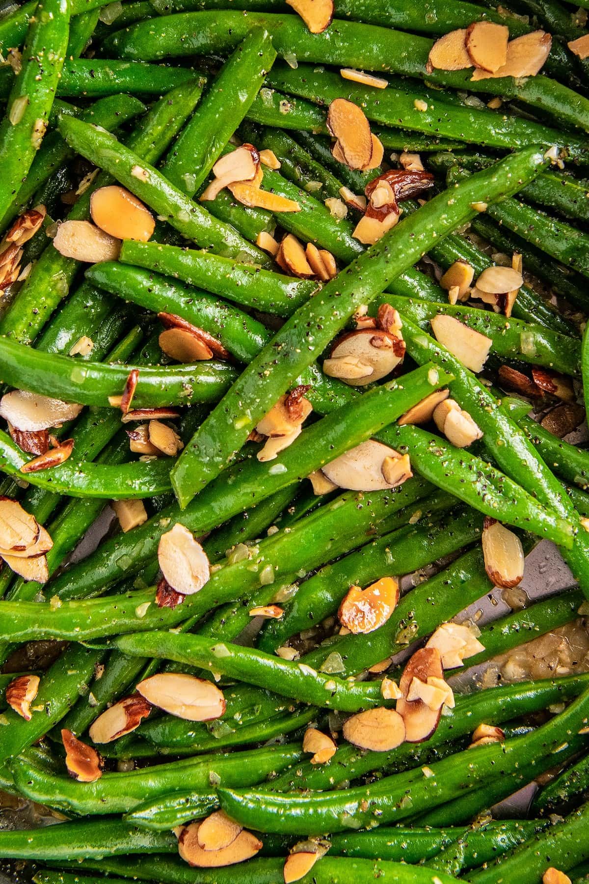 Close up overhead view of green beans topped with almonds