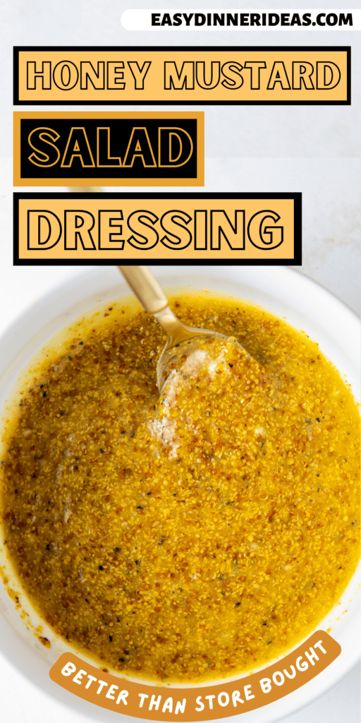 A bowl of honey mustard salad dressing with a spoon stirring it.