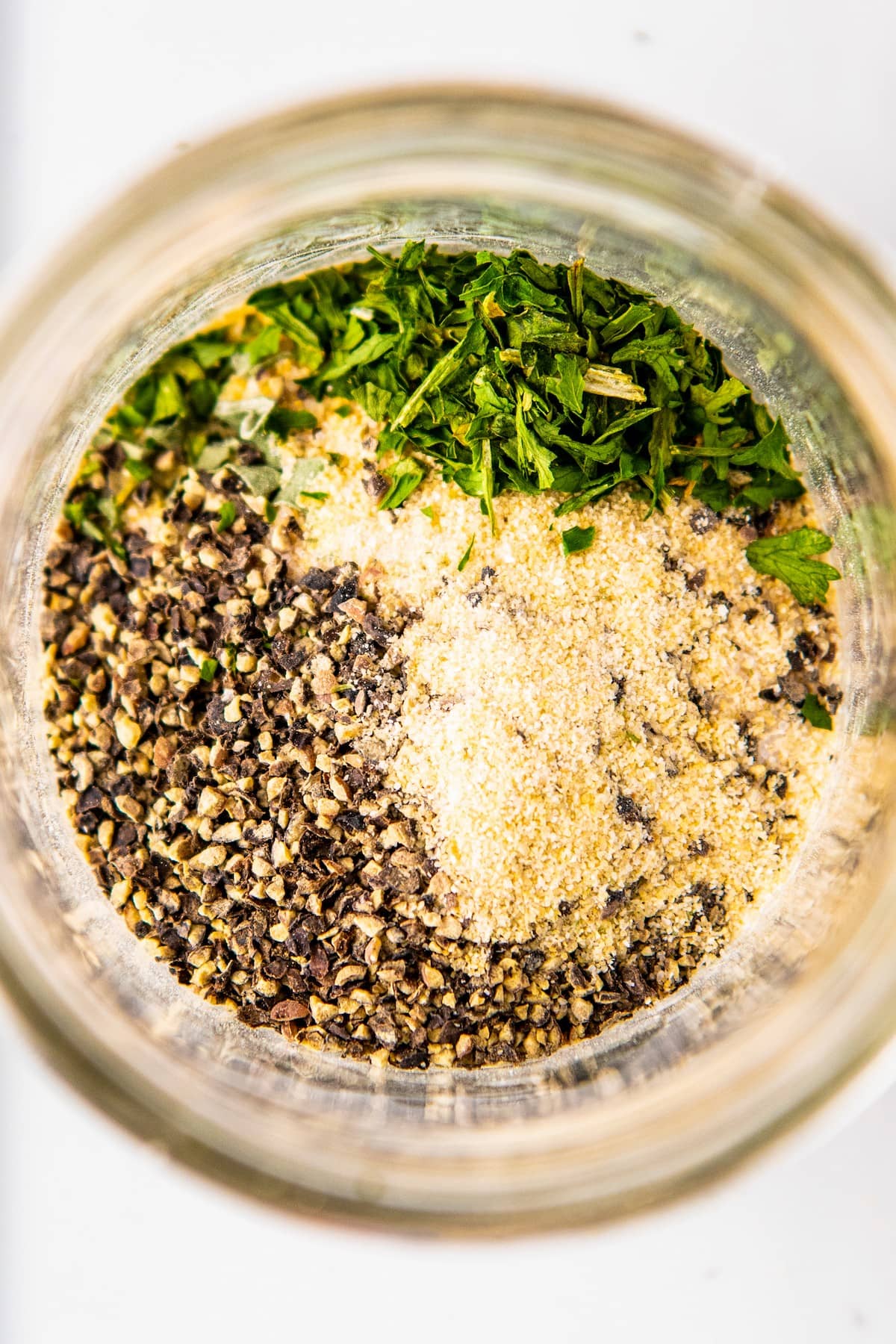 Overhead view of unmixed herbs and spices in a jar