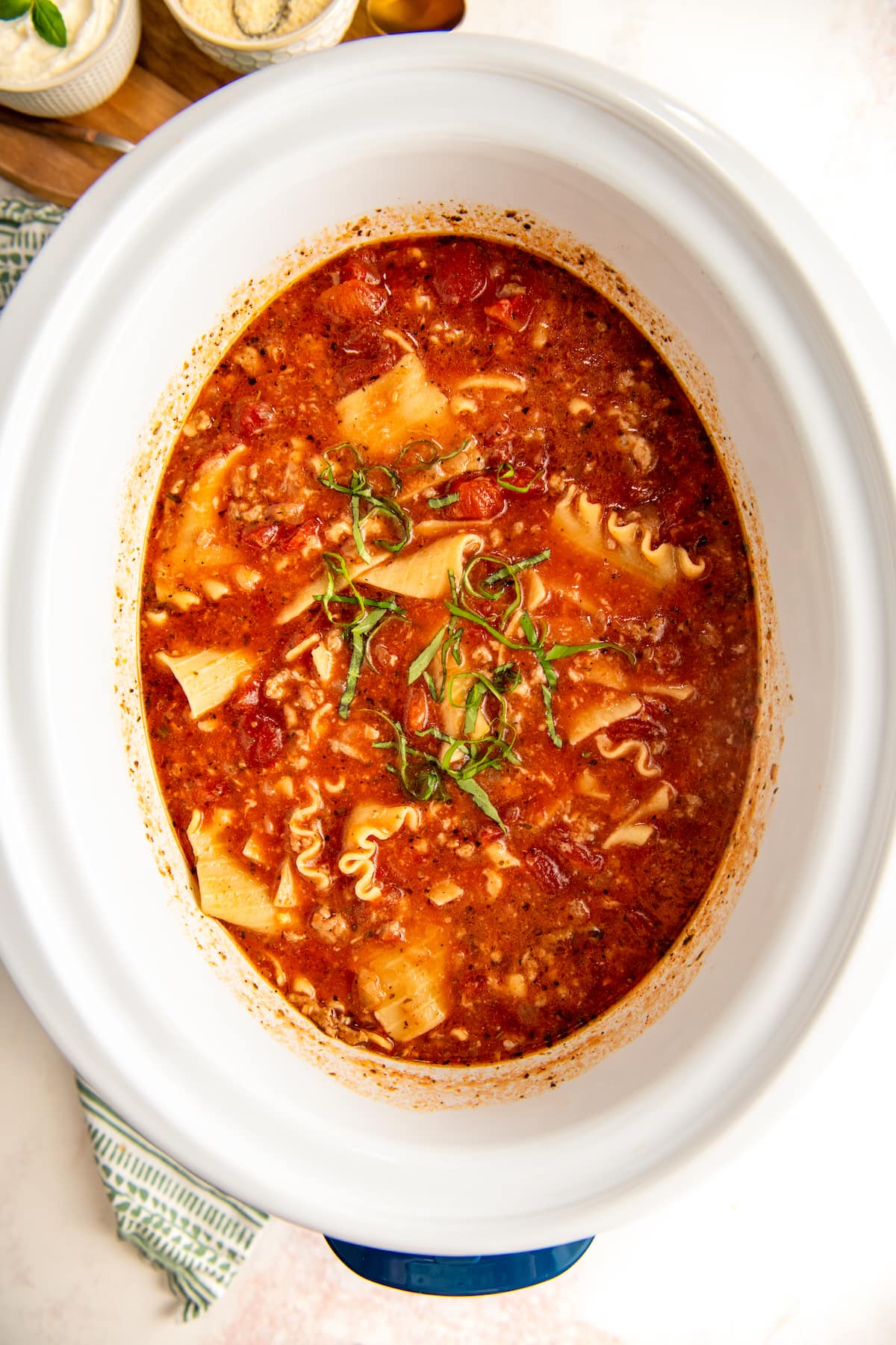 Overhead view of a crockpot full of lasagna soup