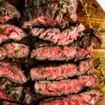 Overhead view of skirt steak sliced on a cutting board