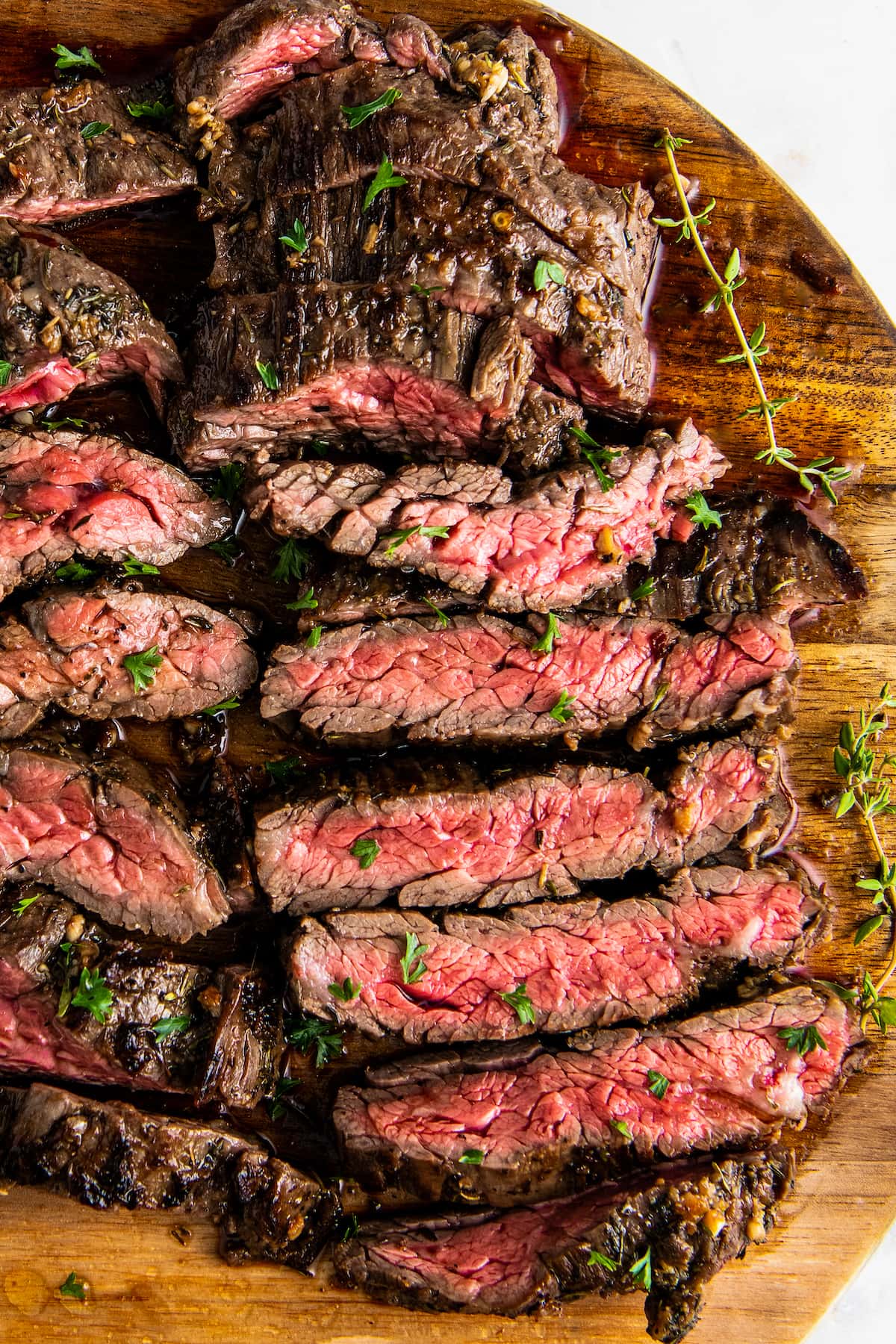 Overhead view of skirt steak sliced on a cutting board