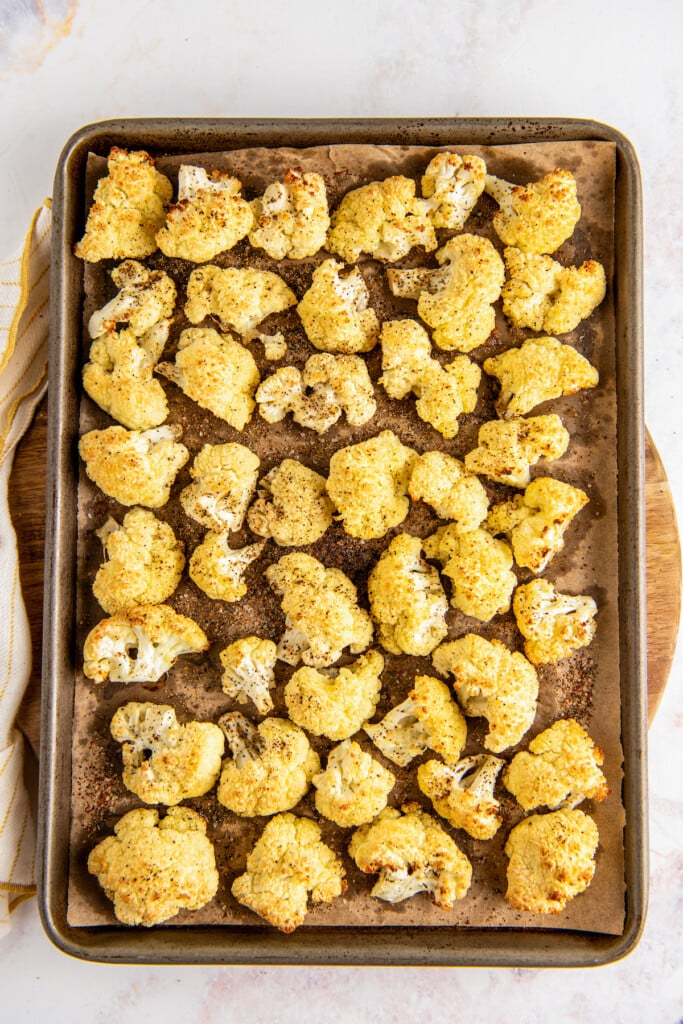 Overhead view of roasted cauliflower on a baking sheet