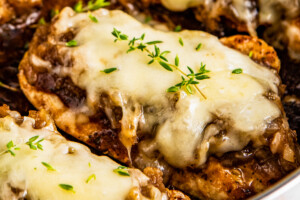 Close up of French onion chicken breasts topped with melted gruyere
