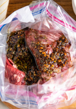 Overhead view looking into an open ziplock bag with skirt steak and marinade