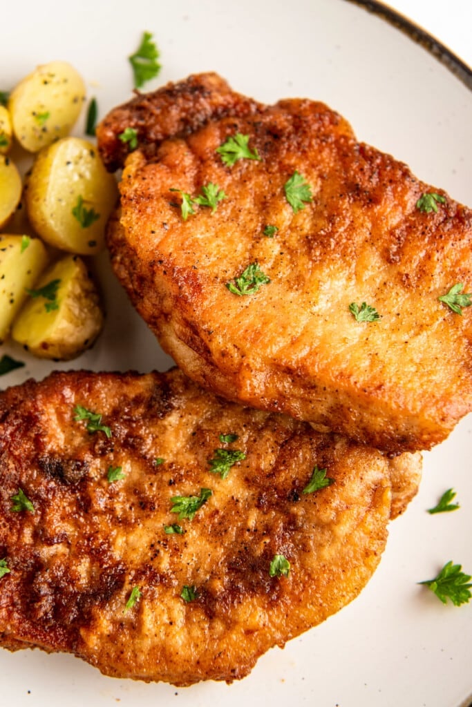 Close up of two pork chops on a plate