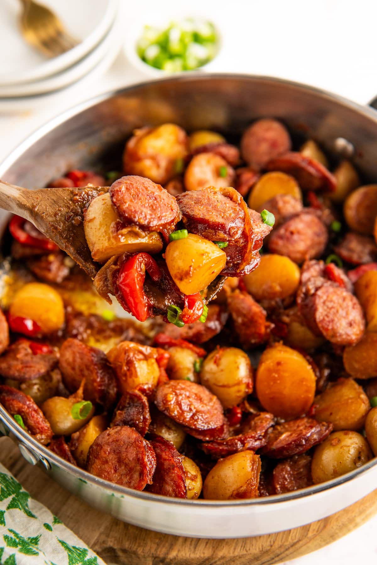 A mixing bowl filled with sausage and potatoes