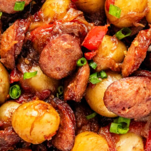 Close up of sausage and potatoes with peppers and green onions