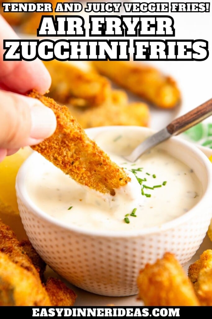 Air Fryer Zucchini Fries being dunked into a bowl of ranch dressing.