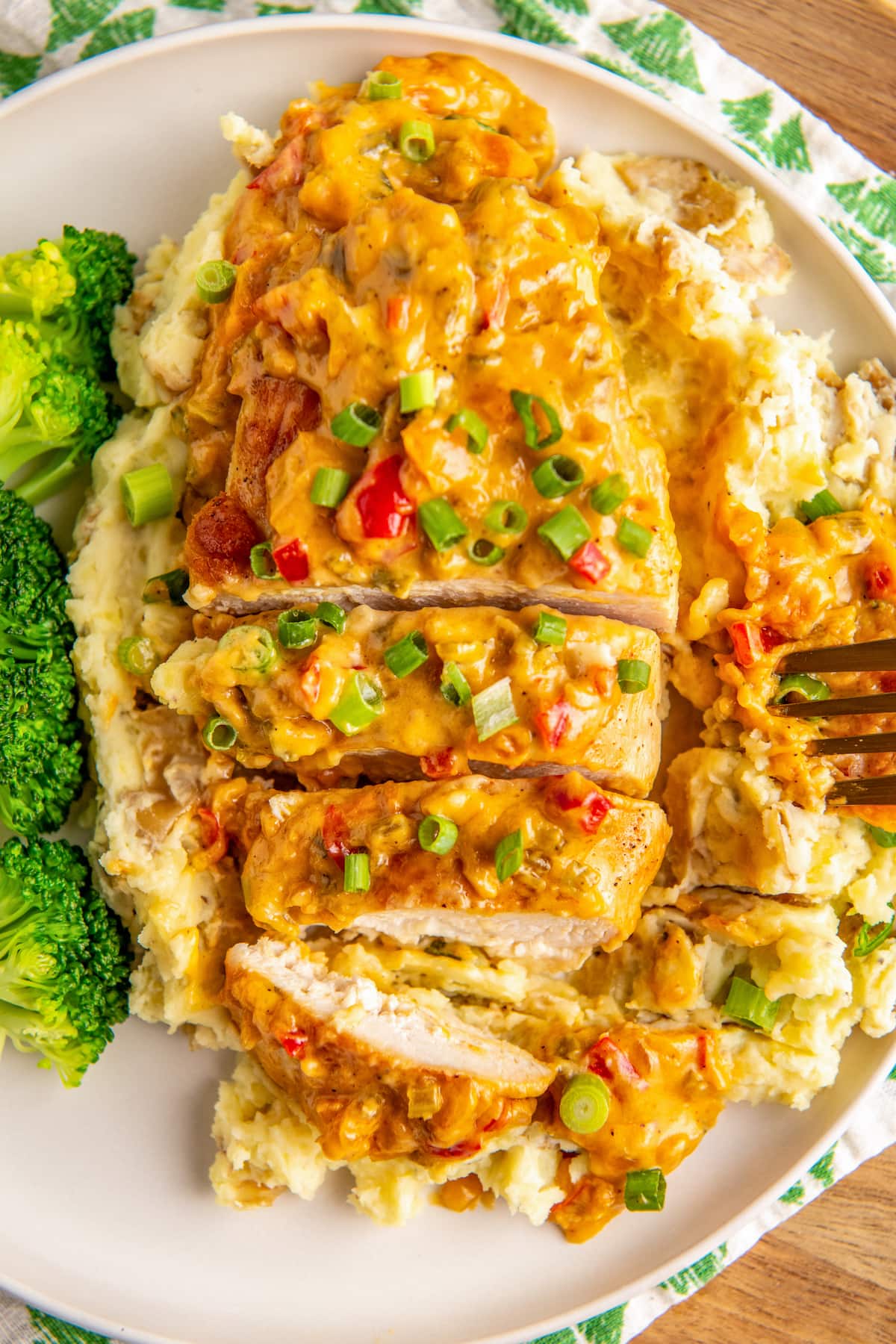 Chicken sliced into pieces and served over potatoes.