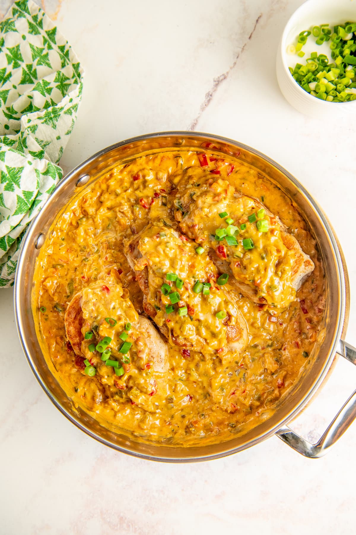 Creamy Cajun chicken garnished with green onions.