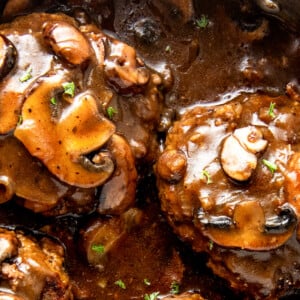 A landscape shot of homemade beef patties in gravy.