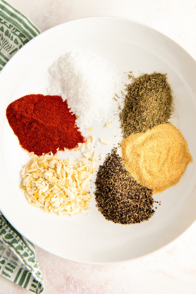 A bowl with colorful herbs and spices in it.
