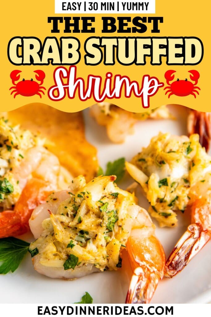 Crab stuffed shrimp on a plate with fresh herbs.