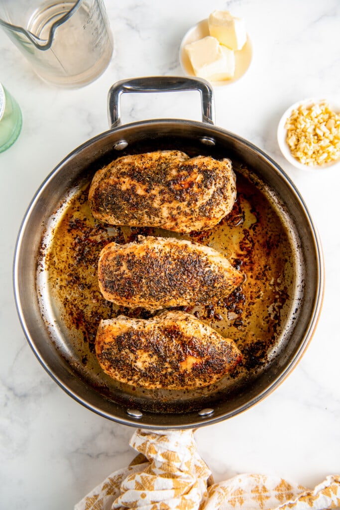 3 chicken breasts seared in a pan