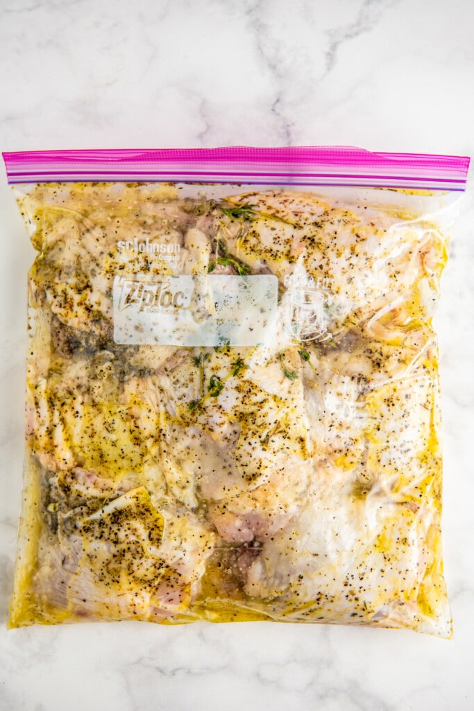 Lemon pepper marinade on chicken in a ziplock bag.