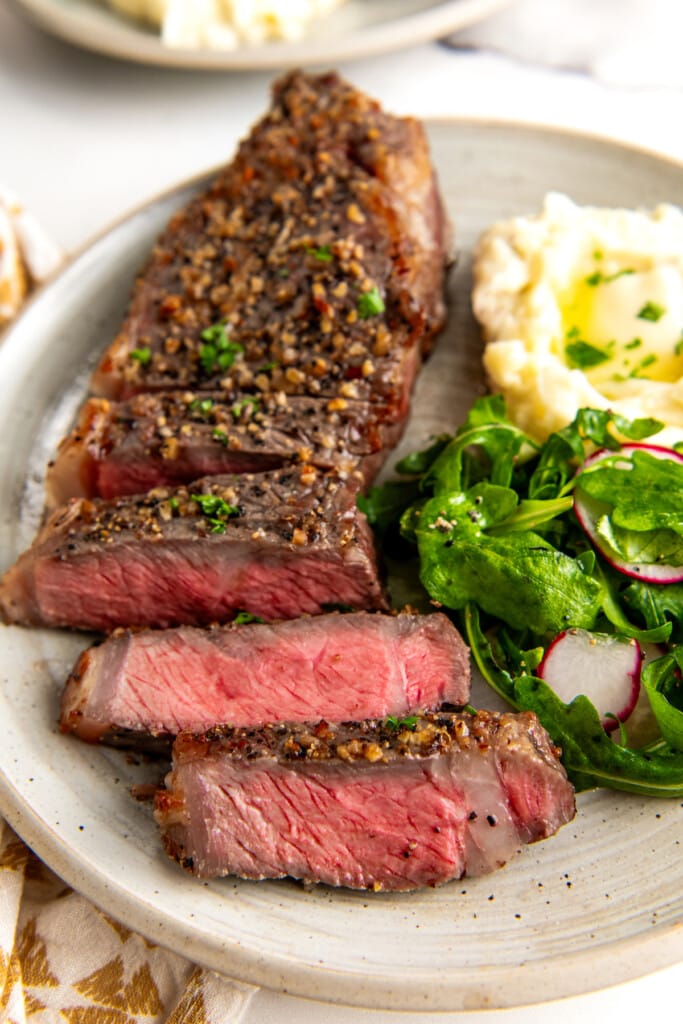 Close up of air fryer steak cut into strips.