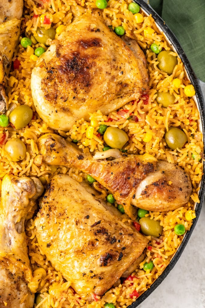 Close up of arroz con pollo in a cast iron skillet.