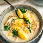 Close up of a bowl of chicken and gnocchi soup.