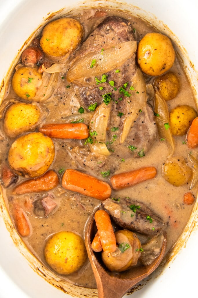 London broil in crockpot cooked in a brown gravy with tender carrots, potatoes and onions.