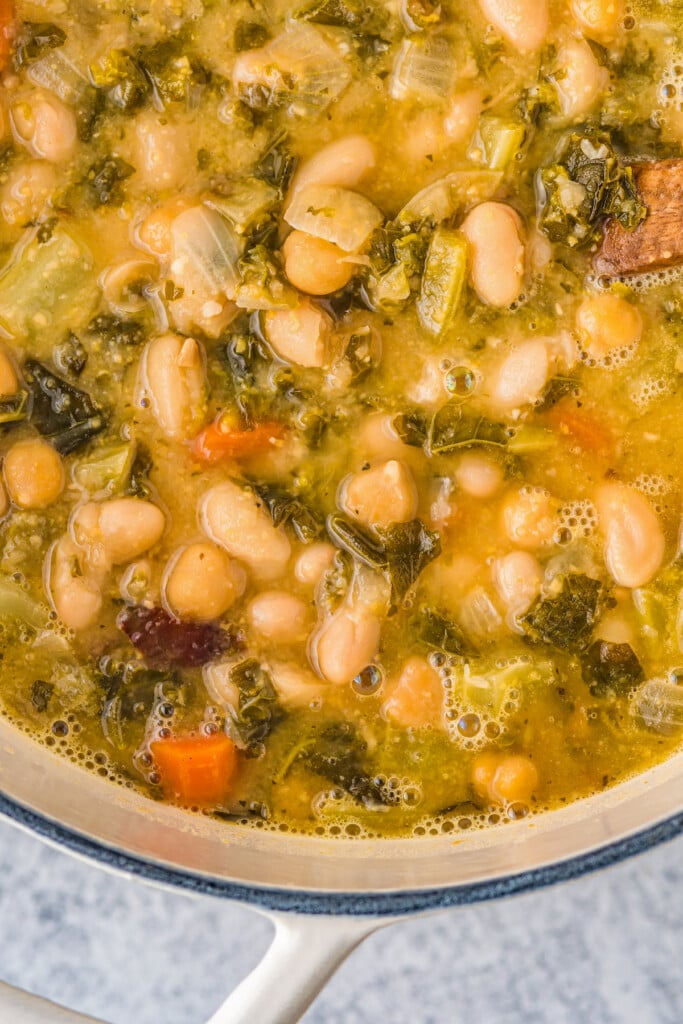 Close up of white bean and kale soup in the pot.