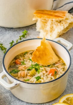 A bowl of white bean soup with a piece of bread alongside.