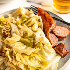 Dinner is served of cabbage and sausage.