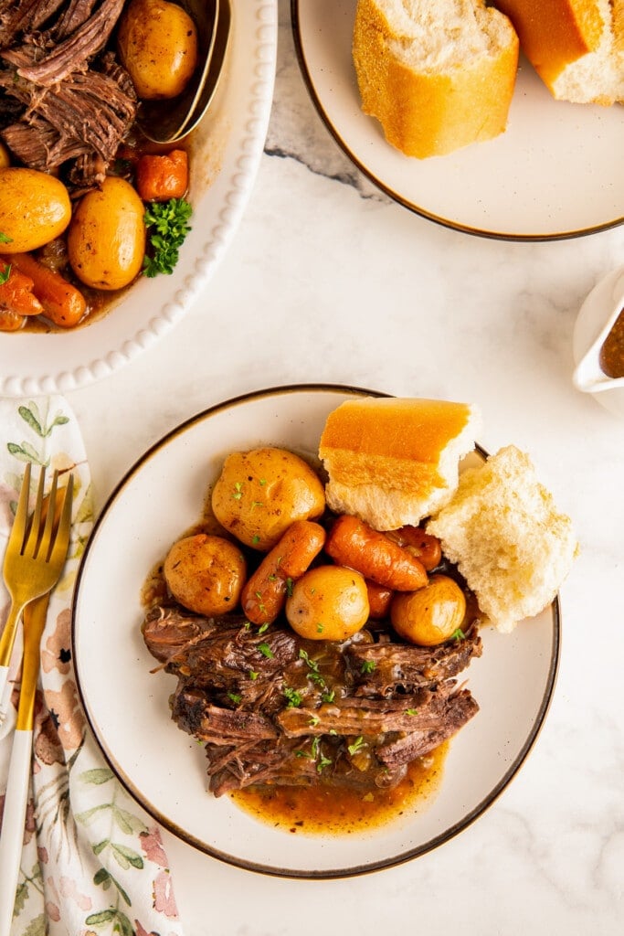 A plate of pot roast with bread.